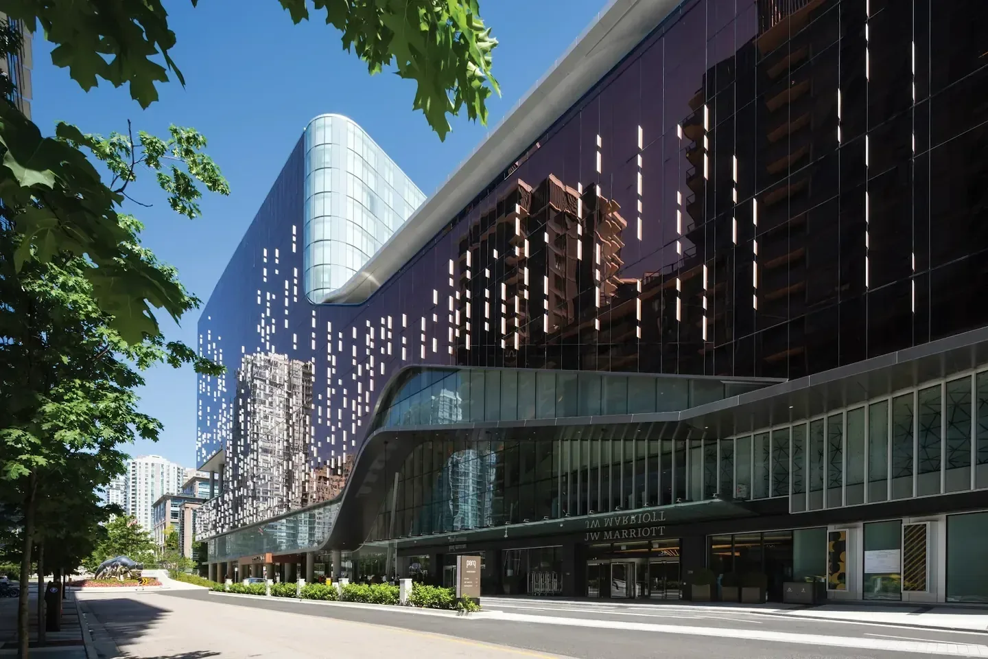 JW Marriott Parq Vancouver, Vancouver — the glass hotel tower seen from the riverfront
